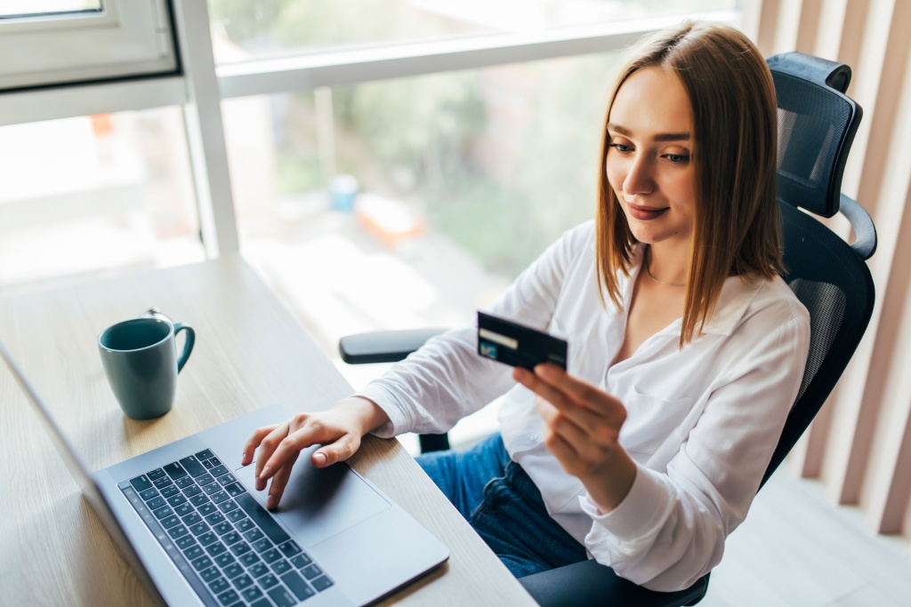 portrait-woman-holding-credit-card-using-laptop-home.jpg окно